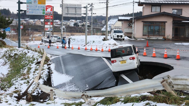 A vehicle rests on the edge of a collapsed road in Tohoku town in Aomori prefecture on Dec. 9, 2025, following a 7.5 magnitude earthquake off northern Japan. 