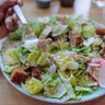 Woman Eats Grilled Chicken Chopped Salad at Restaurant 