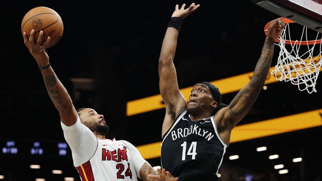 Norman Powell #24 of the Miami Heat goes to the basket as Terance Mann #14 of the Brooklyn Nets defends during the second half at Barclays Center on December 18, 2025 in the Brooklyn borough of New York City. 