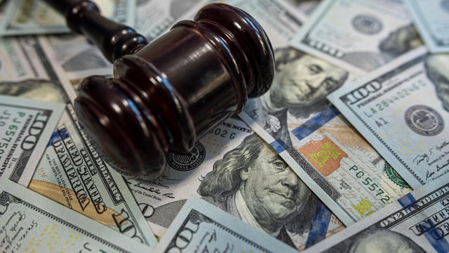 Gavel on hundred dollar bills &ndash; Law and money, justice system, legal fees or corruption concept 