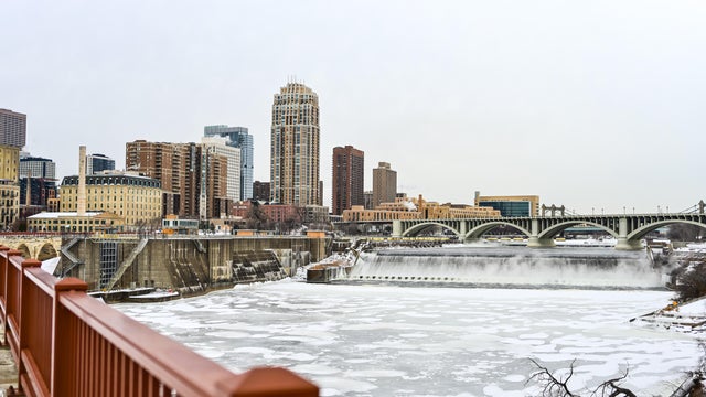 Stone Arch Bridge Railing and Frozen Mississippi River in Downtown Minneapolis in Winter 