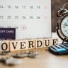 overdue bills concept with deadline calendar remind note,coins,credit card,calculator on table 