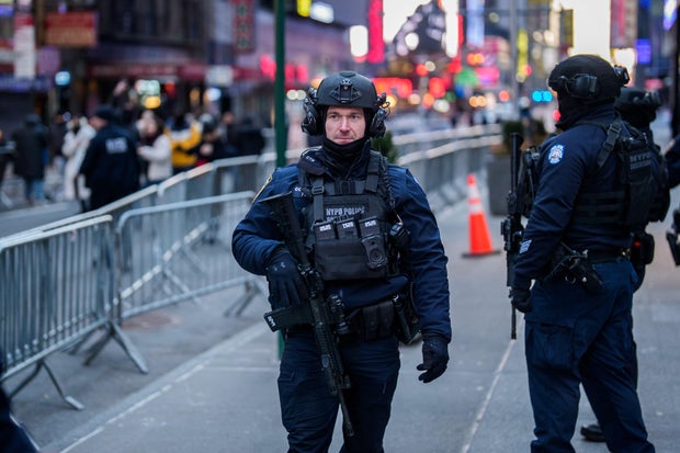 Police stand guard in New York's Times Square on New Year's Eve 