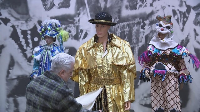 A man works on a costume for the Mummers Parade 