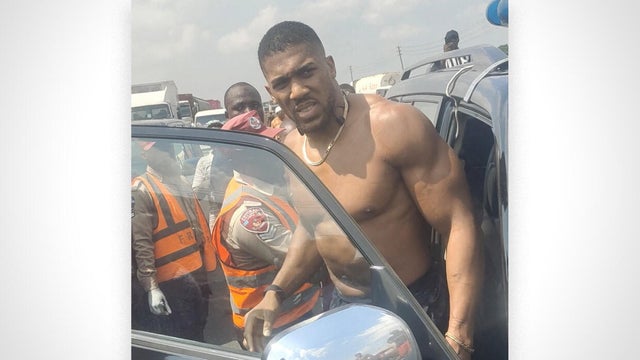 British boxer Anthony Joshua gets into an emergency responders' vehicle after being involved in a car crash in Nigeria's Ogun State 