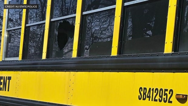 A hole in a side window of a school bus