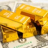Gold bars with US dollar banknote money, finance trading investment business currency. 