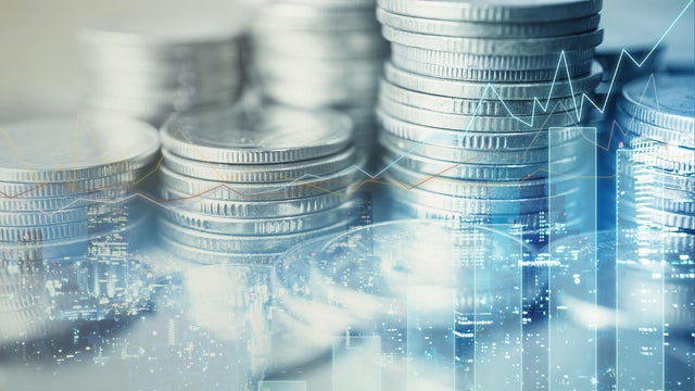 Double exposure of graph and rows of coins 