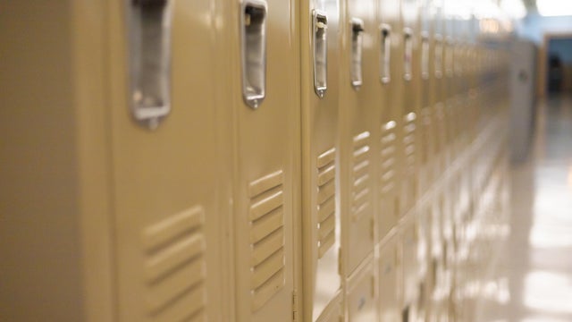 diminishing perspective of row of traditional metal school lockers 
