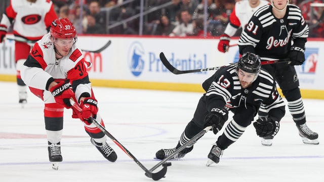 Andrei Svechnikov #37 of the Carolina Hurricanes and Nico Hischier #13 of the New Jersey Devils battle for the puck during the first period of a NHL game against the Carolina Hurricanes at Prudential Center on January 17, 2026 in Newark, New Jersey. 