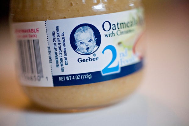 A jar of Gerber oatmeal baby food is arranged for a photogra