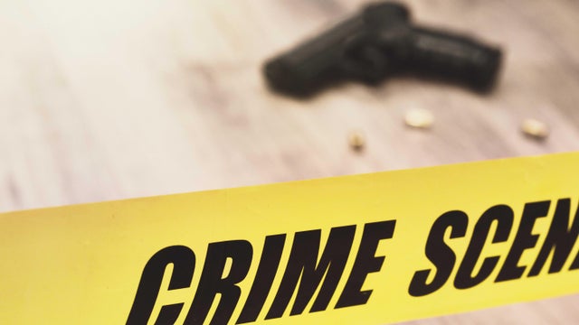 Crime scene tape with pistol and cartridge cases 