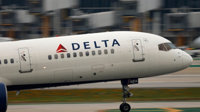 A pilot for Delta Airlines checks his wa 