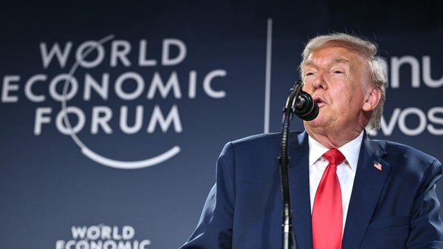 President Trump in front of U.S. and NATO flags 