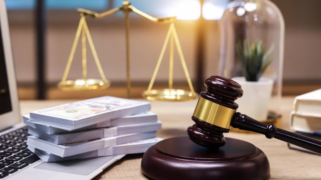 US paper currency on Laptop and gavel,Money with a hammer 