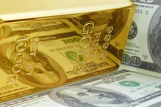 Yellow Gold Ingot Bar with Dollar Bill Reflection. 