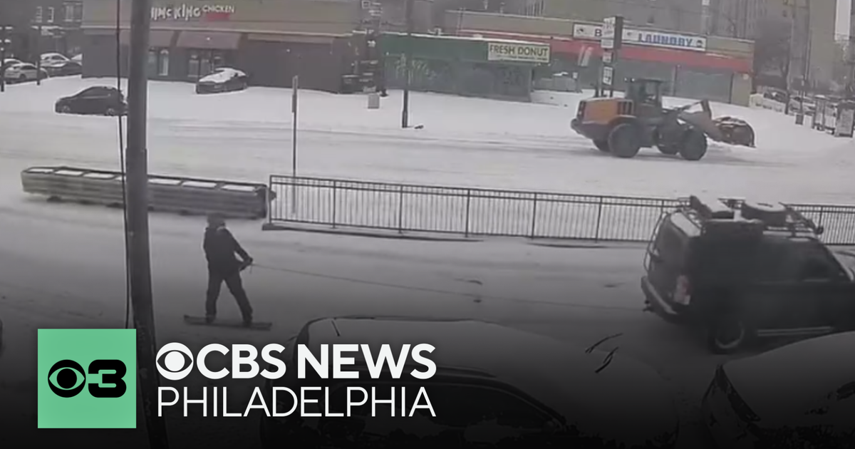 Car pulls "snowboarder" down Girard Avenue in North Philadelphia during storm