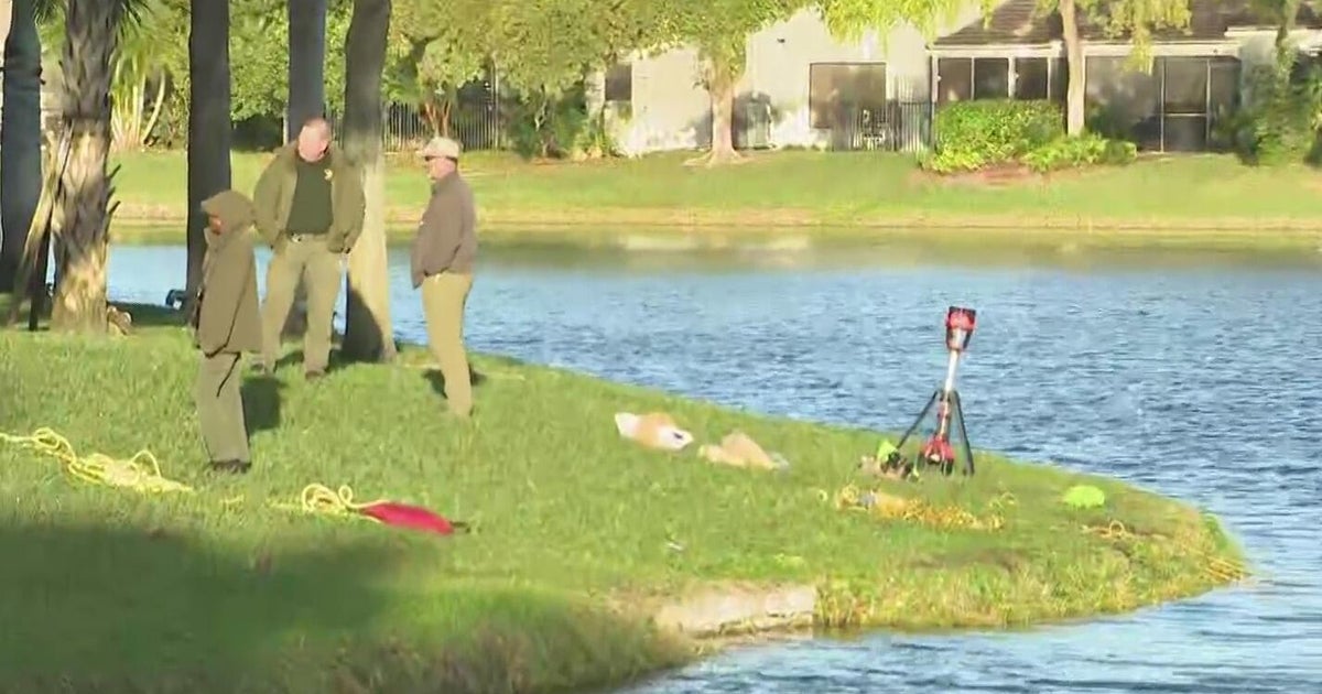 Divers with Broward Sheriff’s Office continue searching Deerfield Beach lake