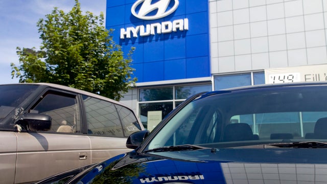 The Hyundai logo is reflected on the hood of a vehicle at Ga 