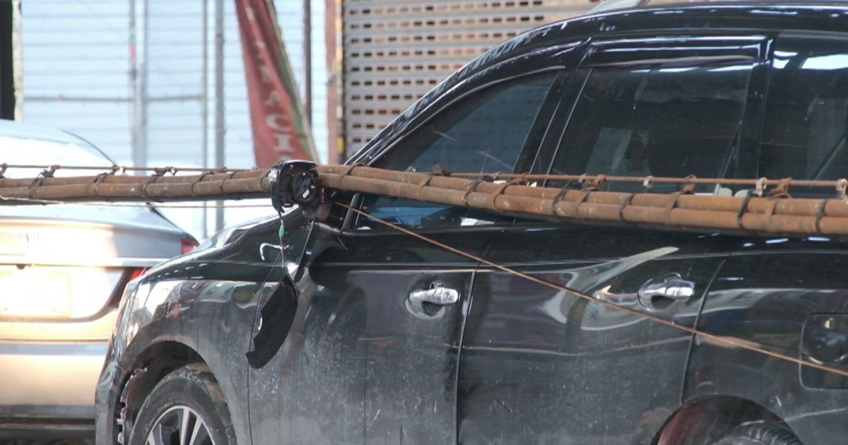 Wires fall from elevated subway tracks in Brooklyn onto cars below