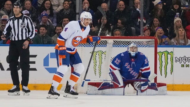New York Islanders' Carson Soucy (4) skartes past New York Rangers goaltender Jonathan Quick (32) after scoring a goal during the second period of an NHL hockey game Thursday, Jan. 29, 2026, in New York. 