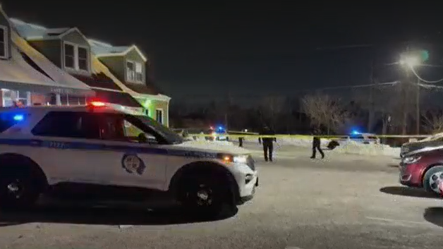 Close Up Shot Focused on Yellow Tape Showing Text Police Line Do Not Cross. Restricted Area of a Crime Scene. Bokeh Background with Flickering Siren Lights. Forensics Team Working on a Case 