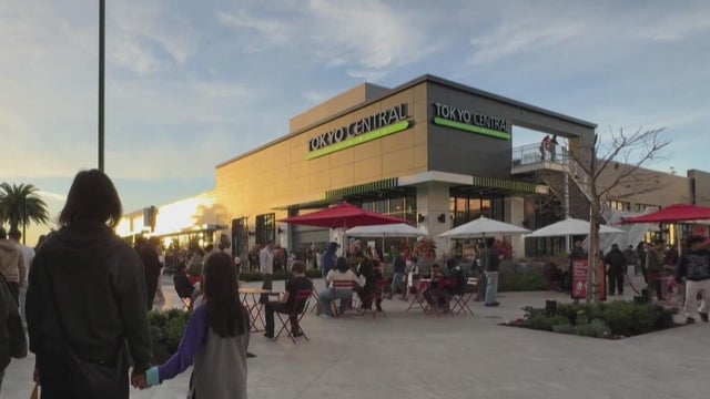 People outside of a new grocery store 