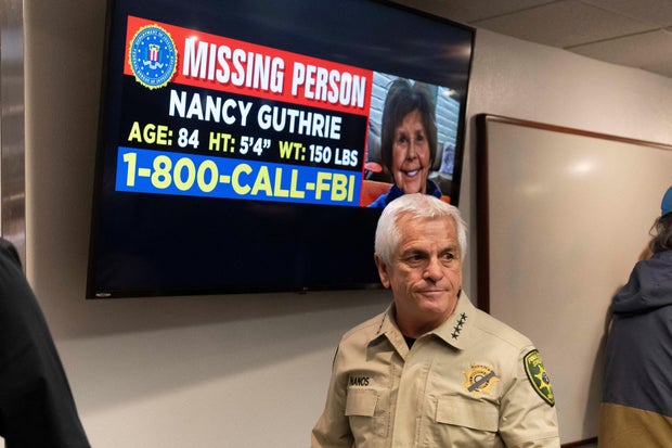 Pima County Sheriff Chris Nanos exits the press room past a missing person poster after giving an update on the investigation into the disappearance of Nancy Guthrie in Tucson, Arizona, Feb. 5, 2026. 