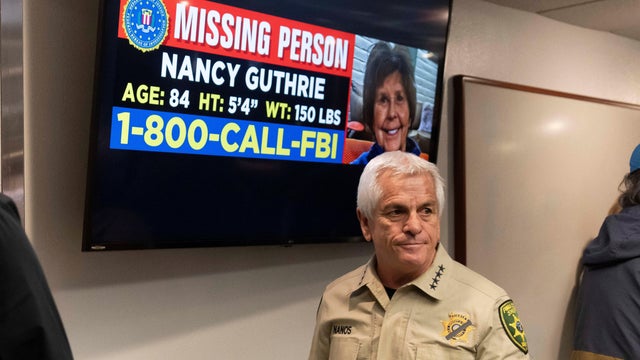 Pima County Sheriff Chris Nanos exits the press room past a missing person poster after giving an update on the investigation into the disappearance of Nancy Guthrie in Tucson, Arizona, Feb. 5, 2026. 