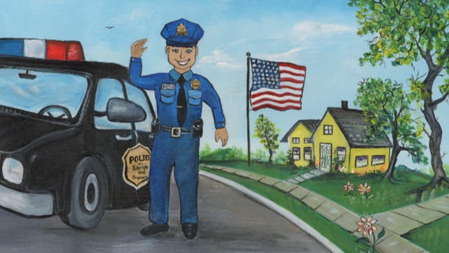 An image from the book, a police officer is in a neighborhood, waving and smiling 