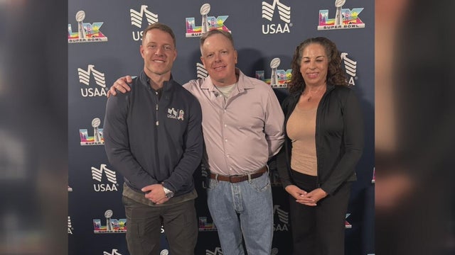 Three people pose for a photo 