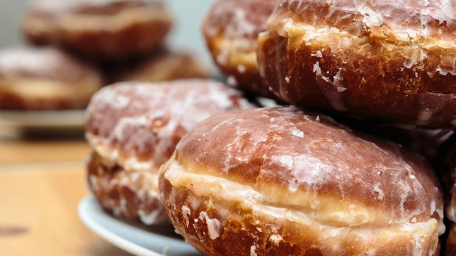 Brown "Paczki" Donuts on White Plate. 