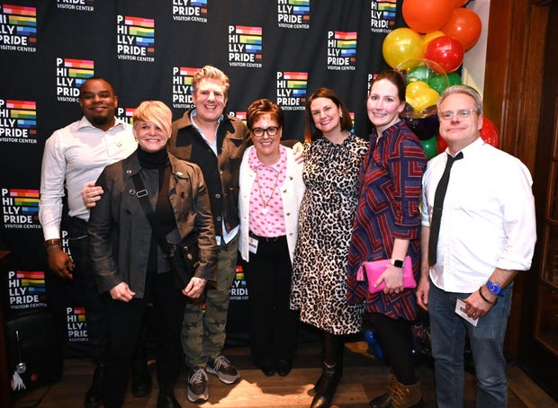 People pose for a photo at the opening of the Philly LGBTQ+ visitor center 