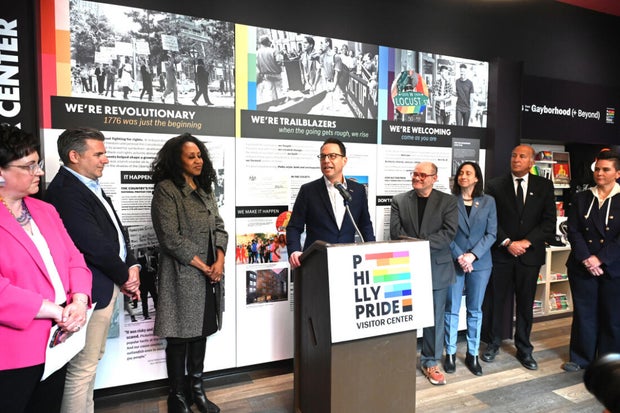 People pose for a photo at the opening of the Philly LGBTQ+ visitor center 