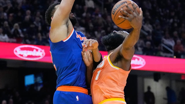 Cleveland Cavaliers guard James Harden, right, is defended by New York Knicks center Karl-Anthony Towns, left, in the first half of an NBA basketball game in Cleveland, Tuesday, Feb. 24, 2026. 
