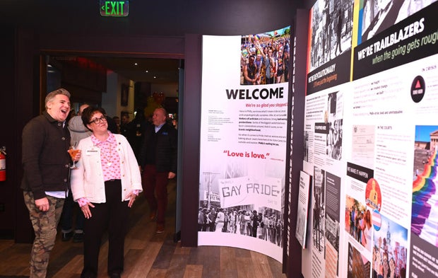 People pose for a photo at the opening of the Philly LGBTQ+ visitor center 