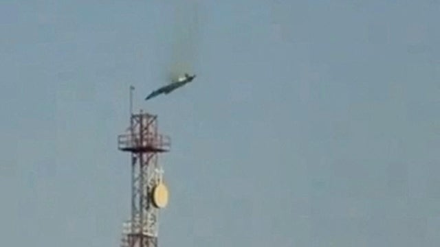 A burning aircraft falls from the sky in Al Jahra, in this still image obtained from social media video 