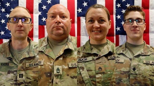 Military soldier's dog tags and American flag 