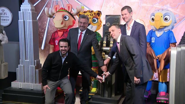 FIFA World Cup officials and mascots throwing the switch to light the Empire State Building 