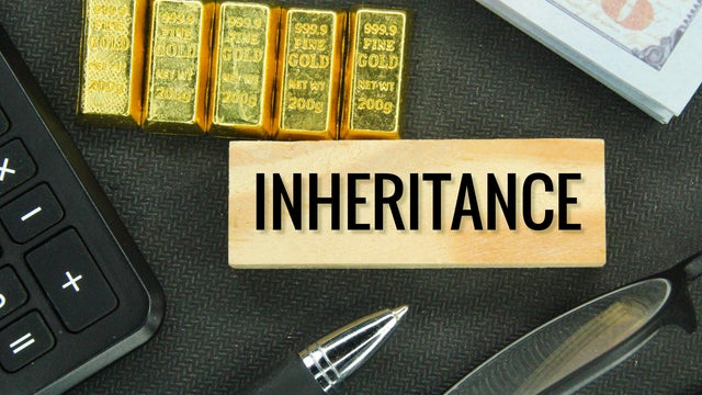 gold, banknotes and wooden boards with the word inheritance 