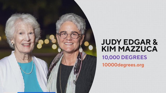 two women who were given an award for helping college students succeed pose for a photo 