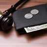 Pocket With Currency Near Judge Gavel Over Desk 