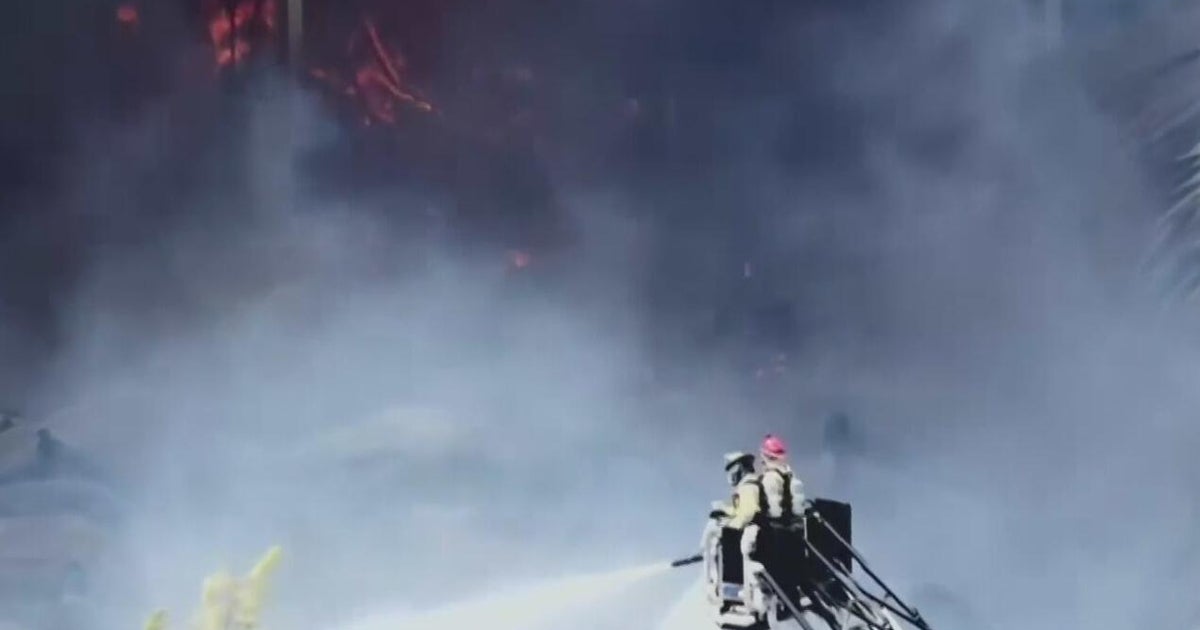 Massive warehouse fire in northwest Miami-Dade is burning for a second night