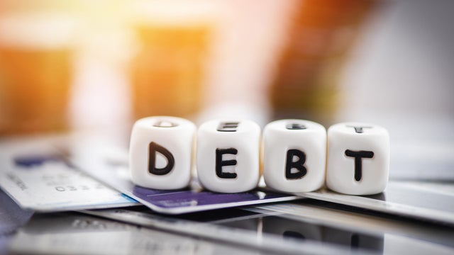 Debt credit card and money coin stack / Increased liabilities from exemption debt consolidation concept 