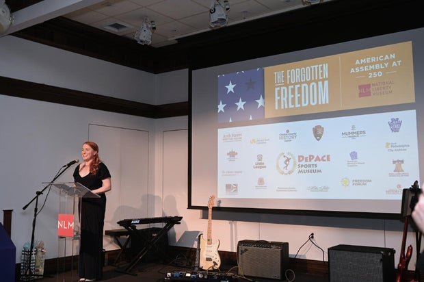 People pose for photos during an event at the National Liberty Museum 
