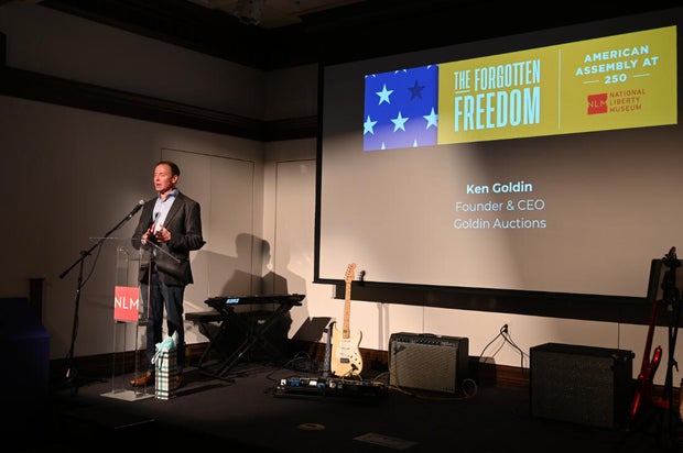 People pose for photos during an event at the National Liberty Museum 