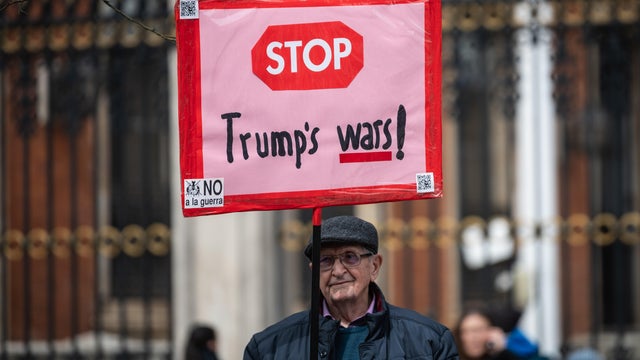 A man holds a placard against US President Donald Trump 