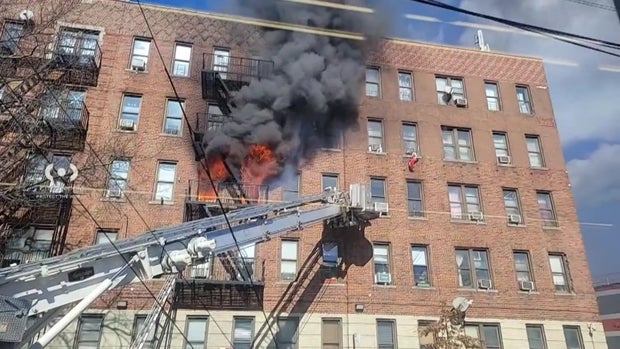 Flames shoot out the windows of a Bronx building 