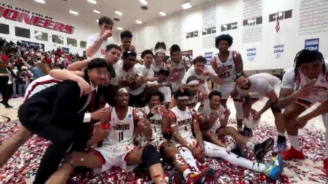 a team of basketball players celebrating a win 