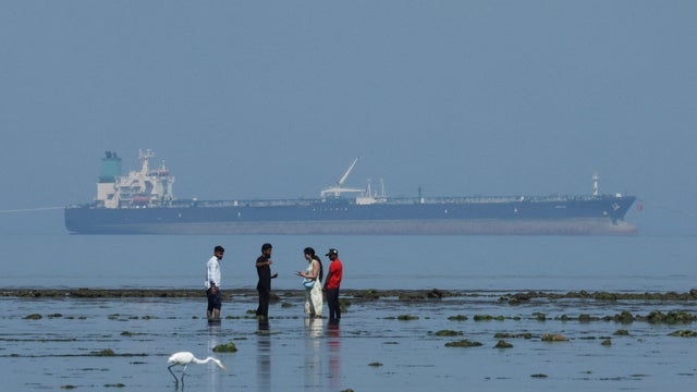 FILE PHOTO: Tourists watch marine life, with the MT Desert Kite oil tanker carrying Russian oil in the background, at Narara Marine National Park in the Arabian Sea 